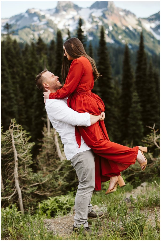 husband picking up wife in romantic  elopement photos at mount rainier by kelly lemon photography