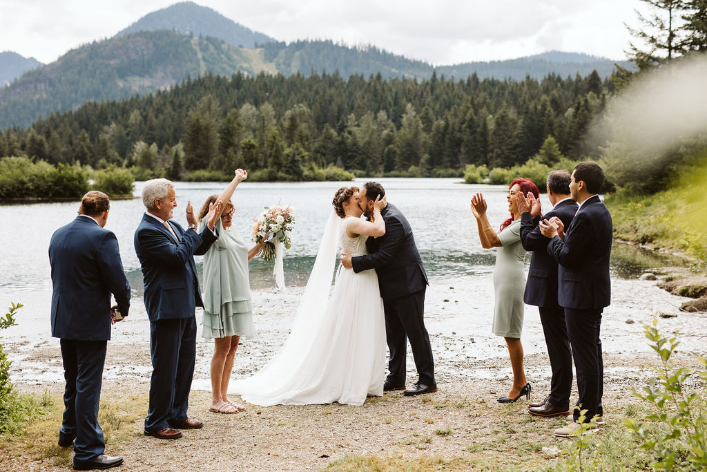 bride and groom kiss at ceremony at gold creek pond