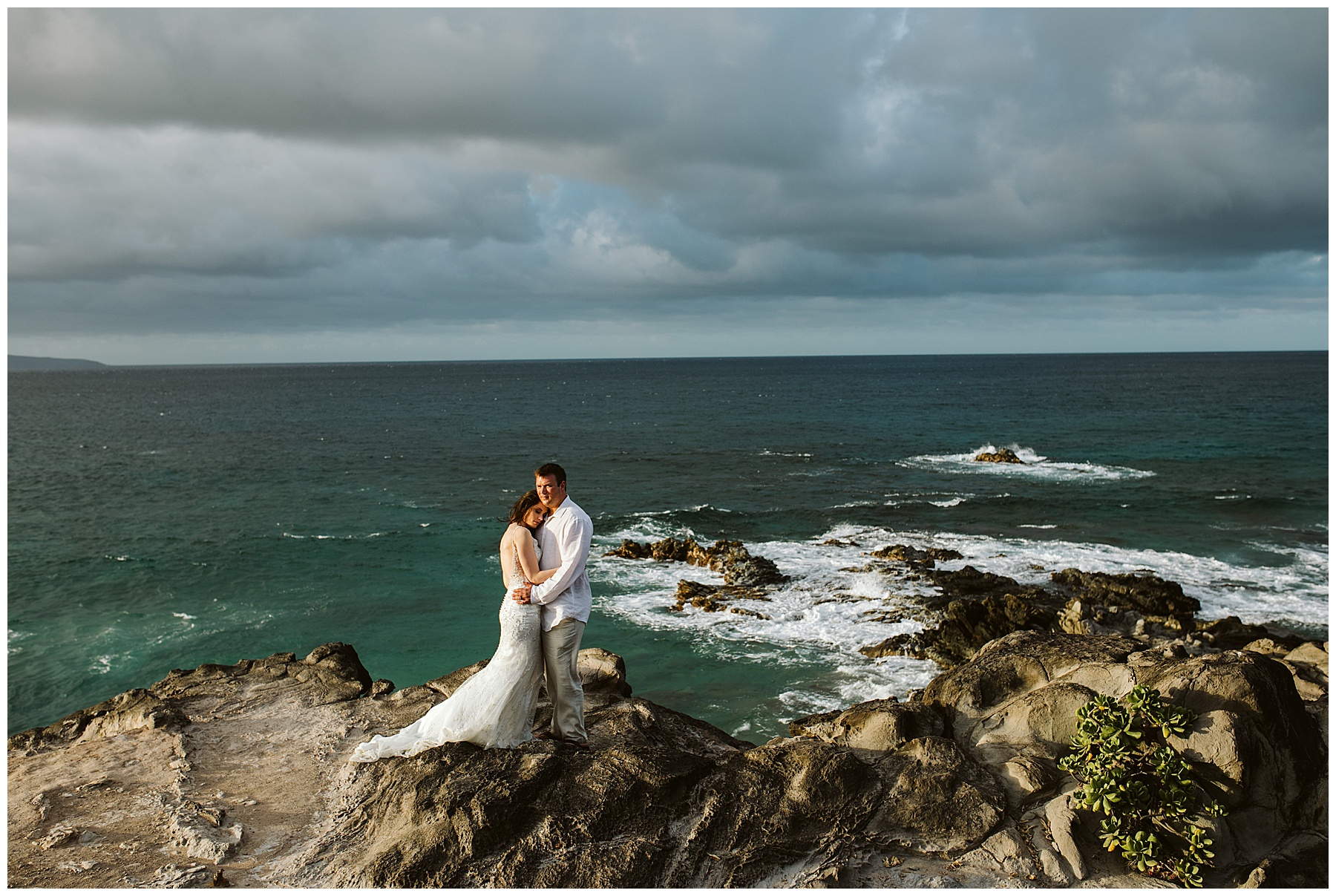 one reason to elope is to have an experience in a beautiful place like this couple, who stands on the cliff edges overlooking the ocean in their elopement attire.
