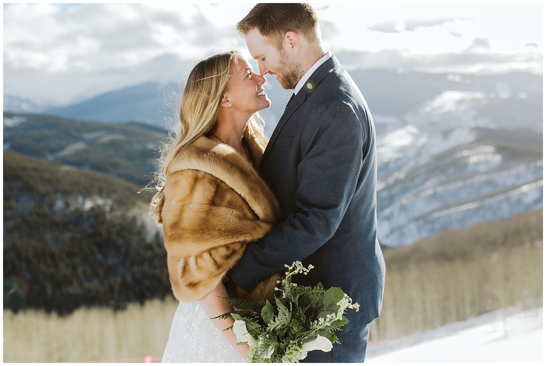 couple stands embracing in the winter snow at their elopement. authentic moments like these are just one reason to elope!