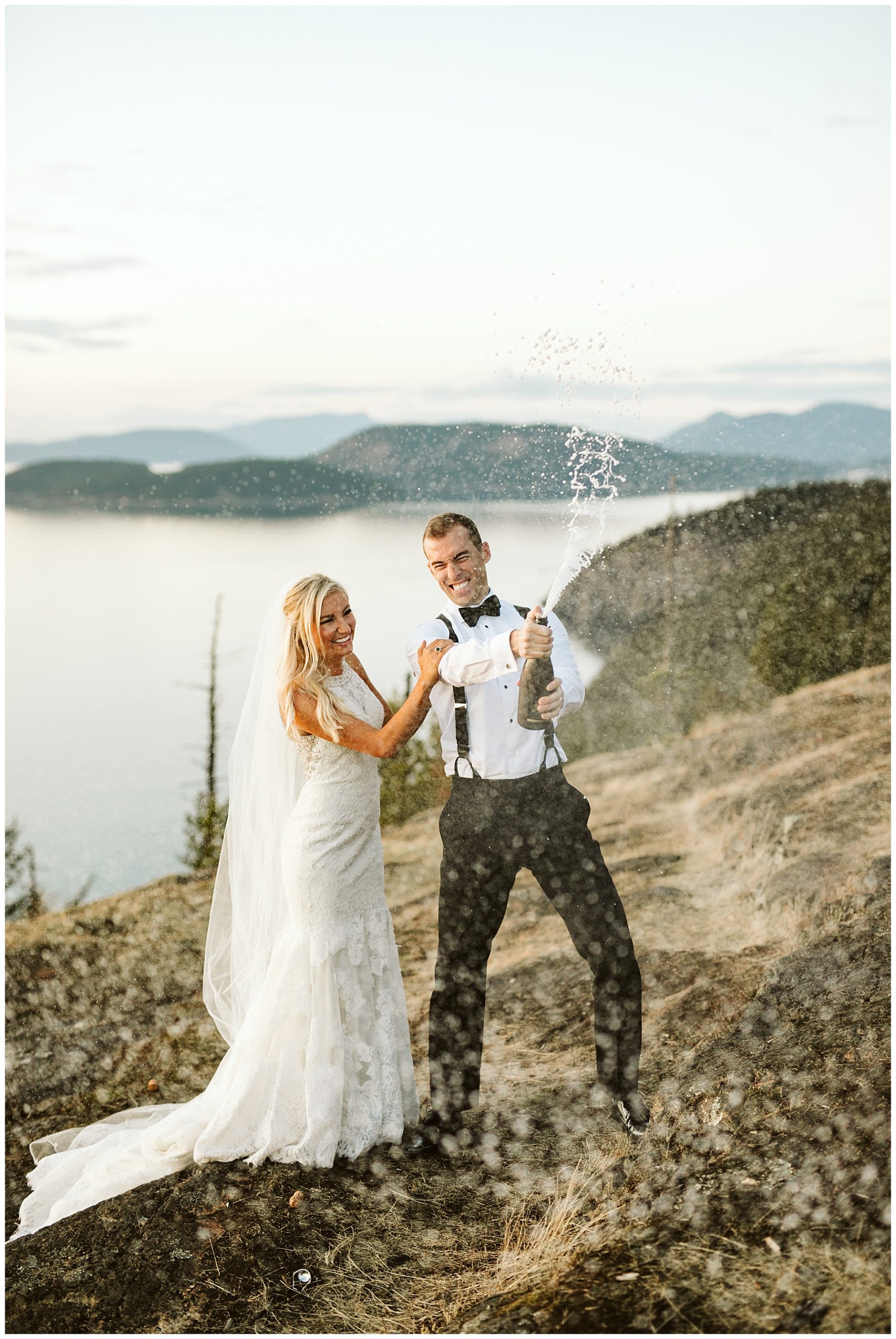 couple sprays champagne in celebration after their elopement.