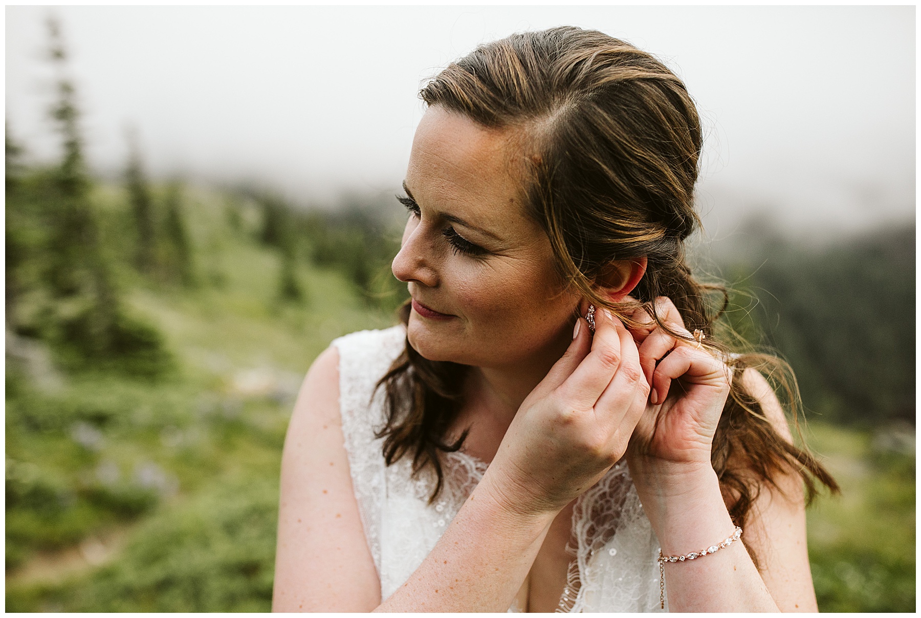 emily puts her earrings in before her elopement ceremony in mount rainier national park.
