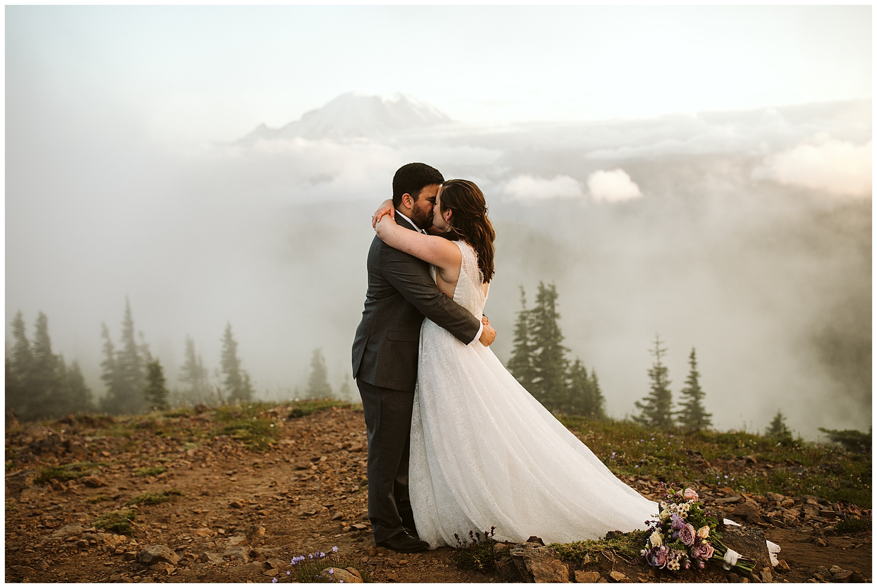 couple shares a kiss at mount rainier during their elopement.
