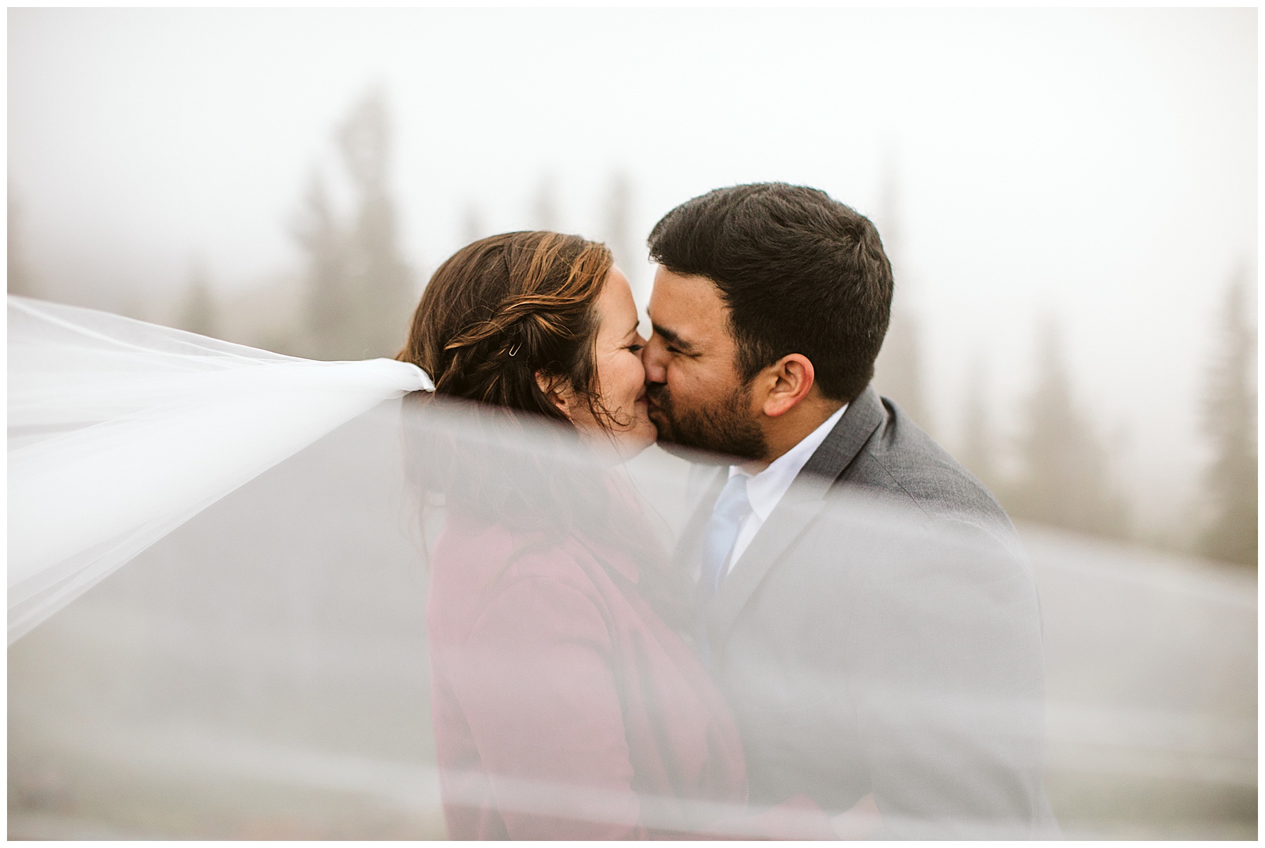couple shares a kiss at their elopement in mount rainier national park.