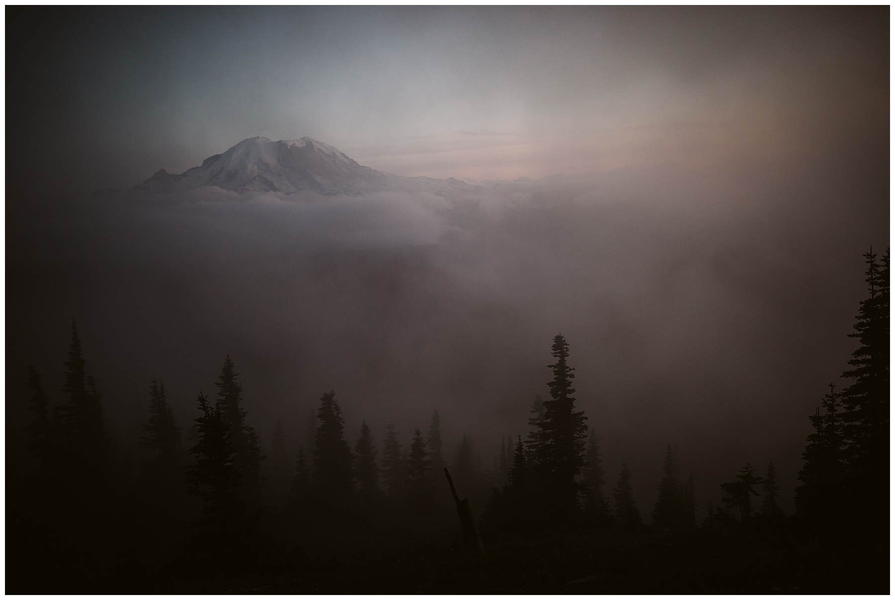 mount rainier at sunset on a foggy day after emily and jay's elopement.