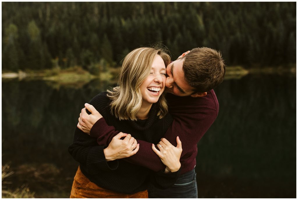 couple kissing and laughing maroon sweater 