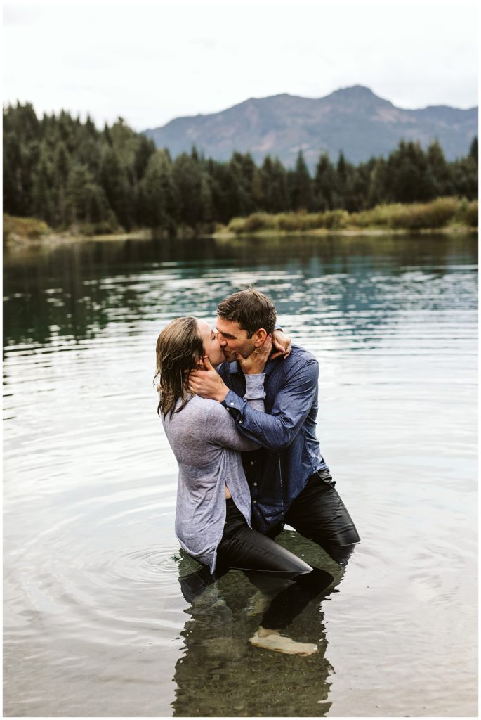 couple wet in lake and kissing 
