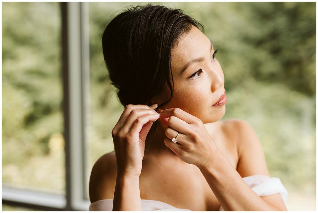 pnw novelty hill wedding bride putting on earring 