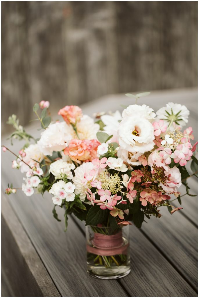 bridal bouquet in vase pink flowers pink ribbon