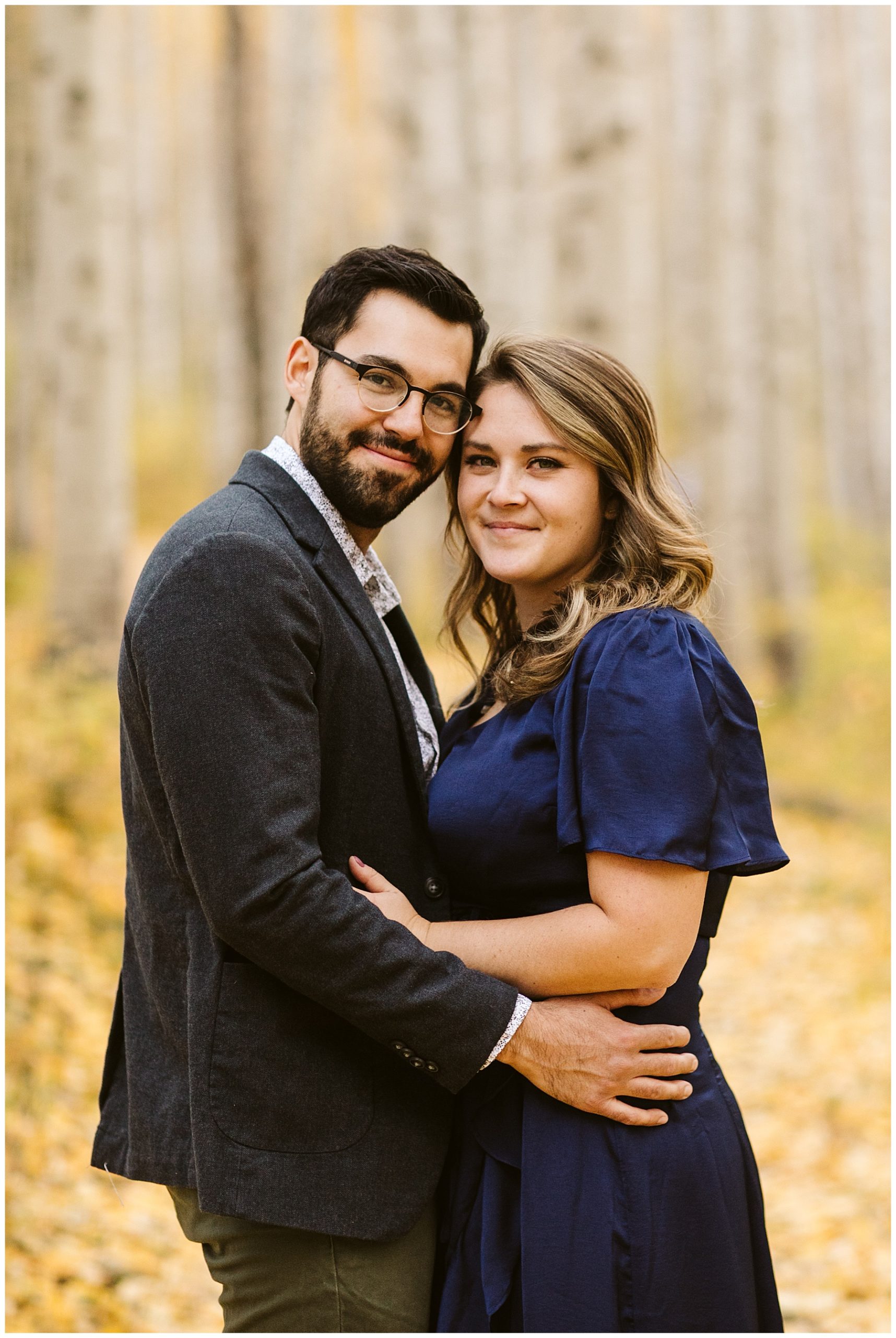 engagement portrait of couple in fall aspen forest