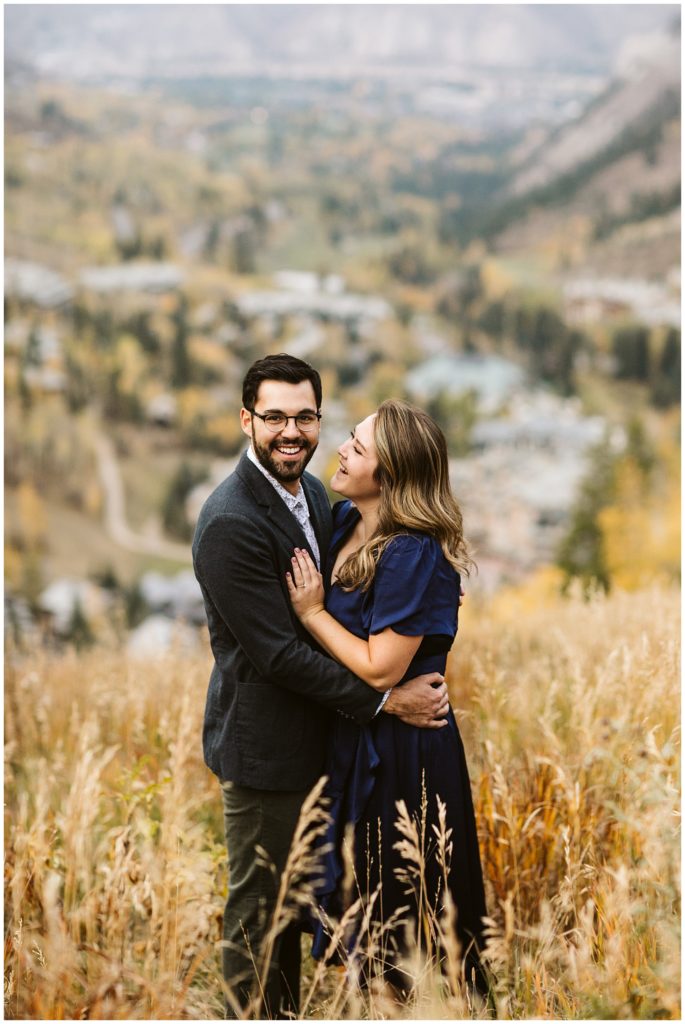couple laughing with fall background
