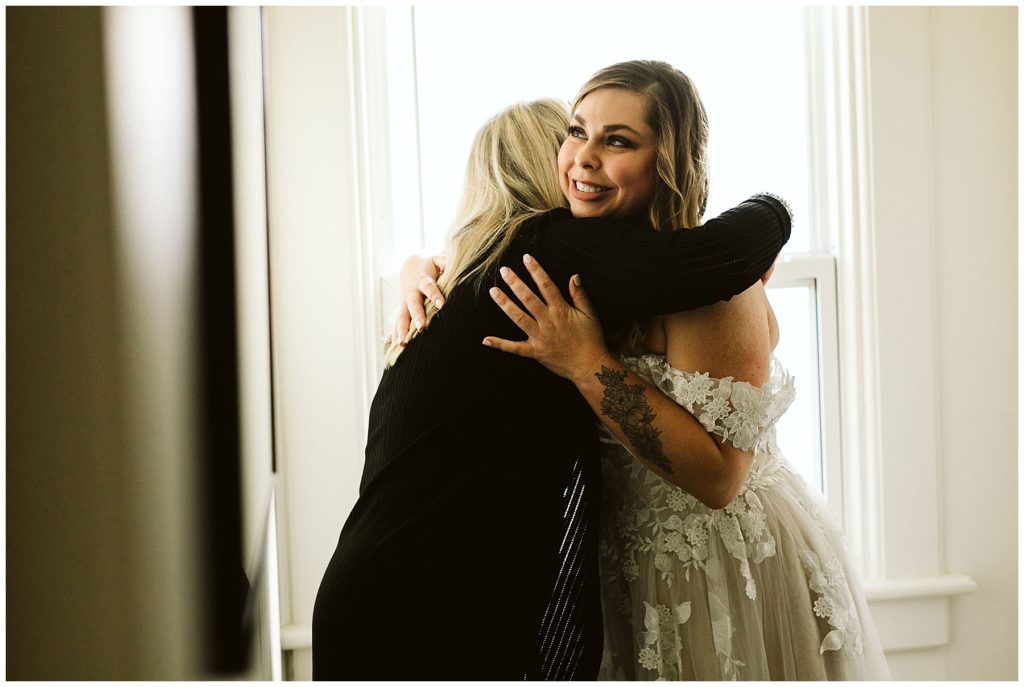 mom hugging her daughter on her wedding day vashon island elopement