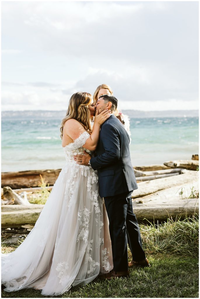 couple kissing with water and beach background