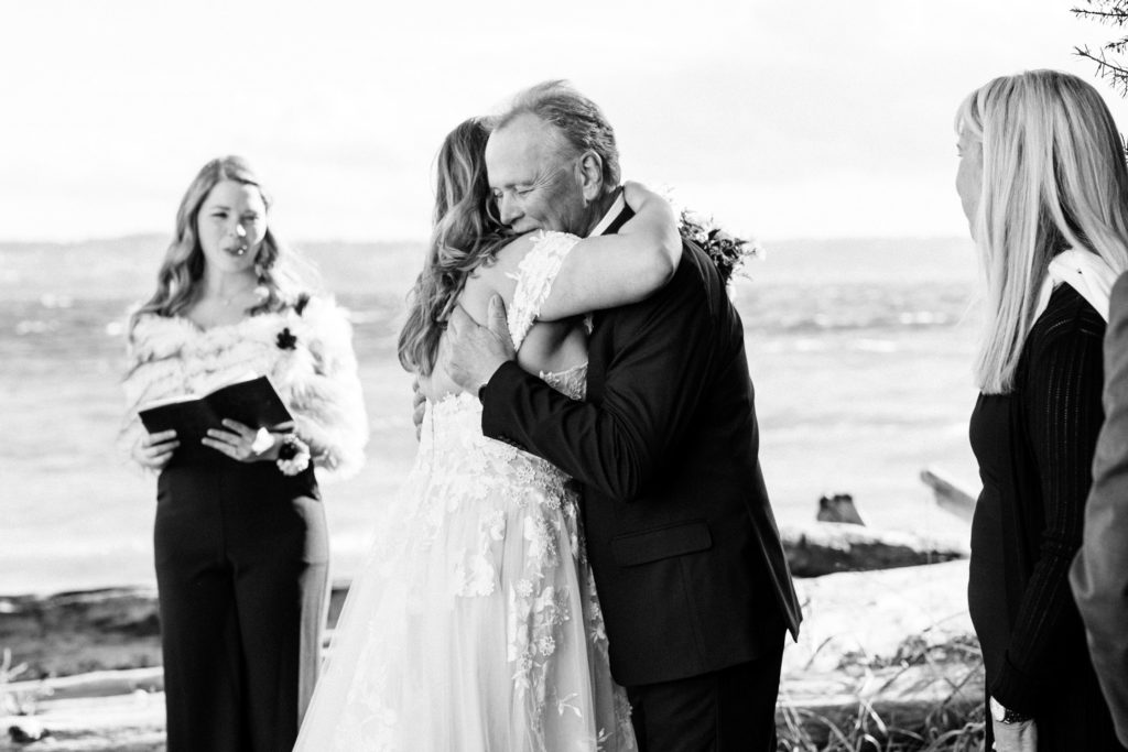 bride and dad hugging white and black photo