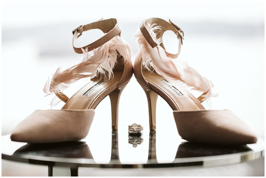 pink wedding shoes with feathers and wedding rings