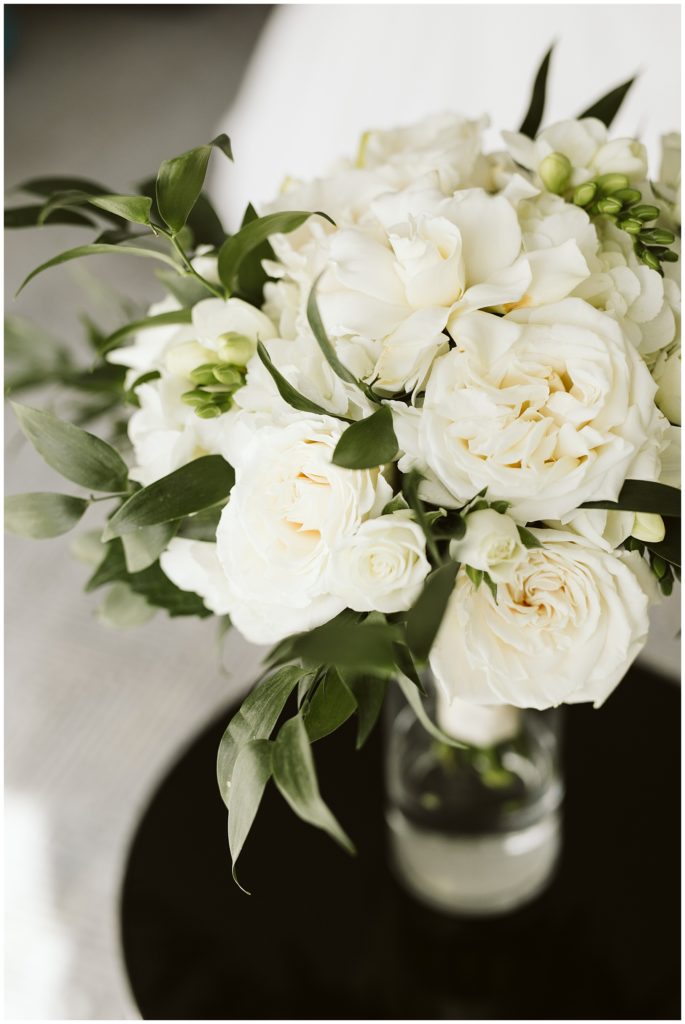bridal bouquet with fresh white roses and dark greenery