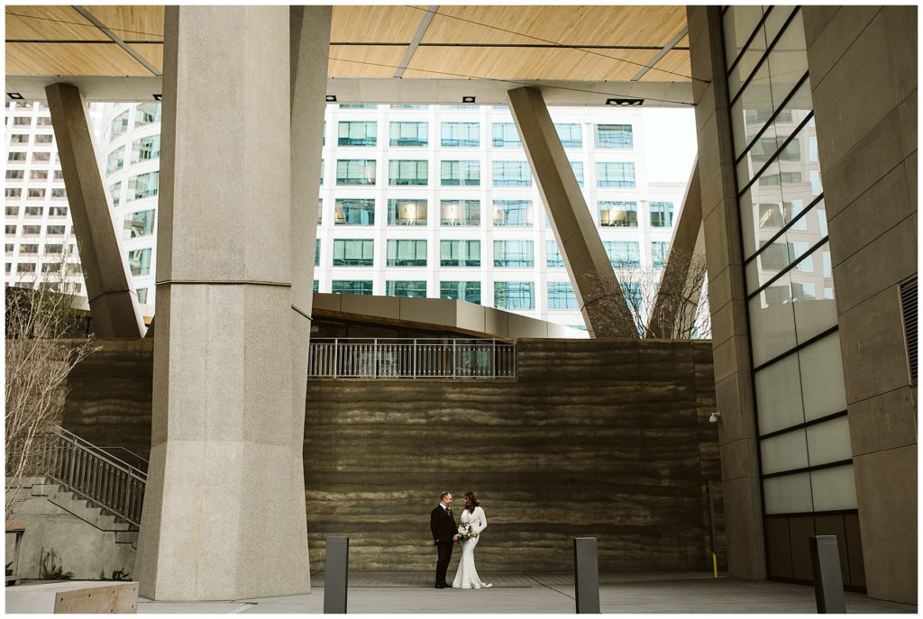 perspective shot of couple far away with modern architecture