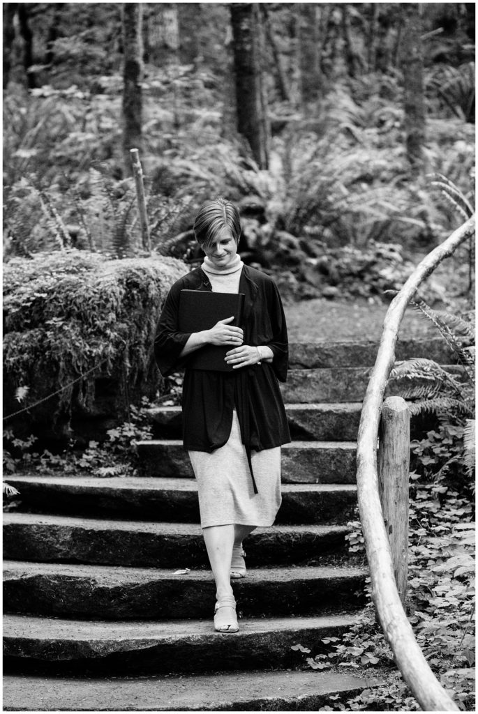 officiant walking down forest steps to begin wedding black and white photo