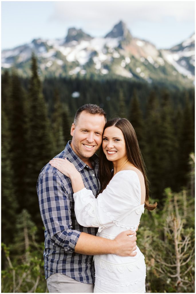 beautiful couple standing as a portrait with the forest in the background shot by kelly lemon photography at mount rainier