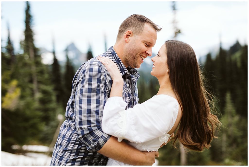 brunette women being held by her husband while they do an outdoor photoshoot for their elopement with kelly lemon photography