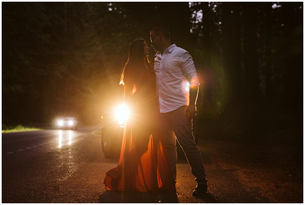 couple standing in front of jeep headlights at the base of mount rainier for their elopement shot by kelly lemon photography