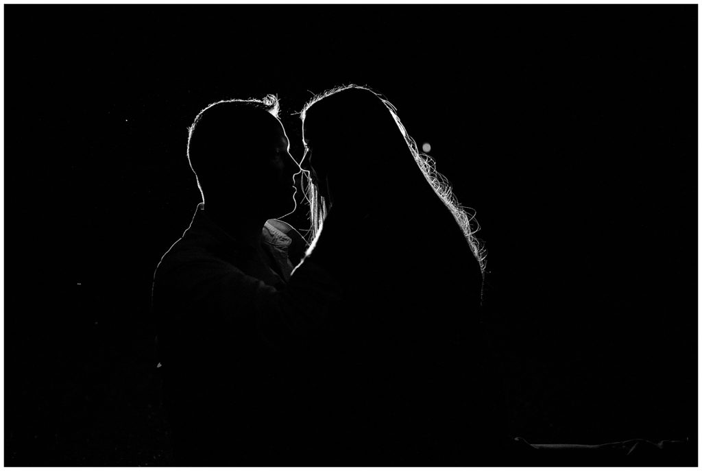black and white photo of silhouette of couple at mount rainier 