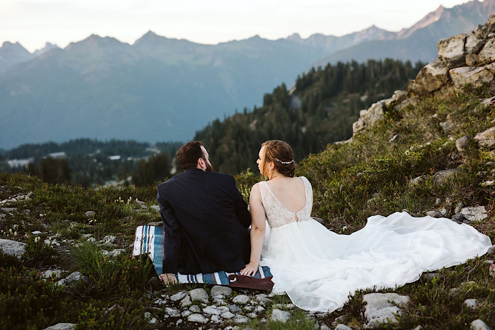 Mt. Baker Sunset Elopement bride and groom sit on picnic blanket
