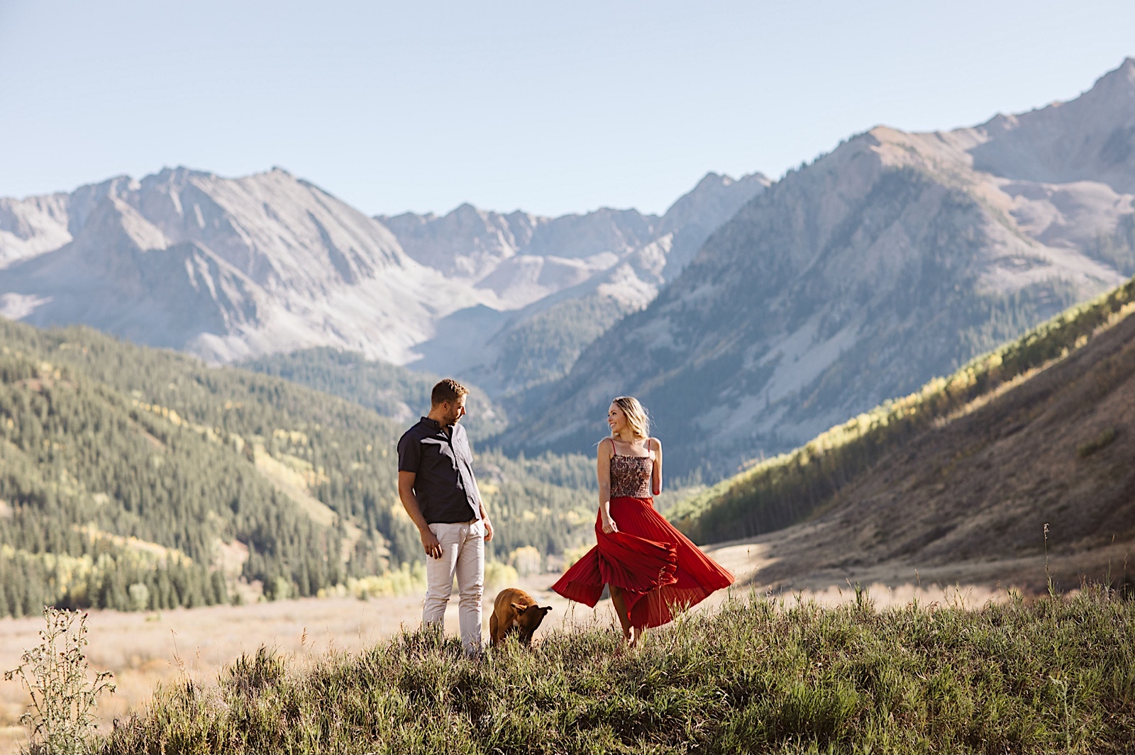 leave no trace photography: engaged couple dancing in the mountains
