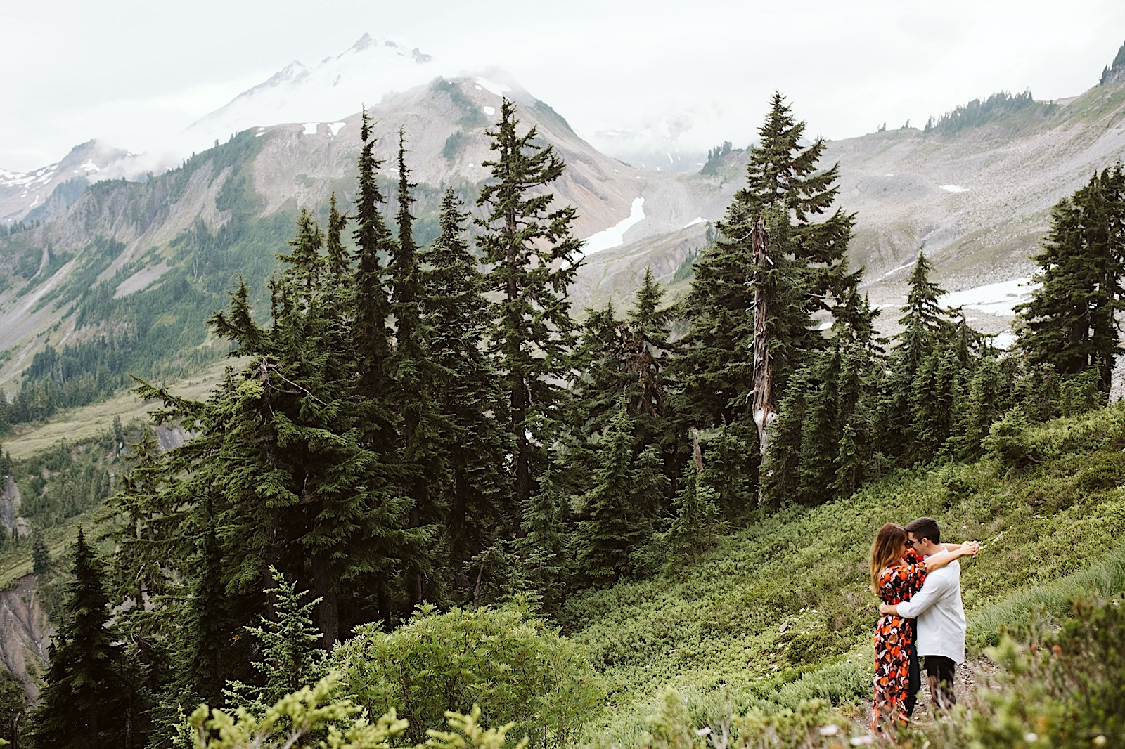 couple embraces on the mountain at mt. baker