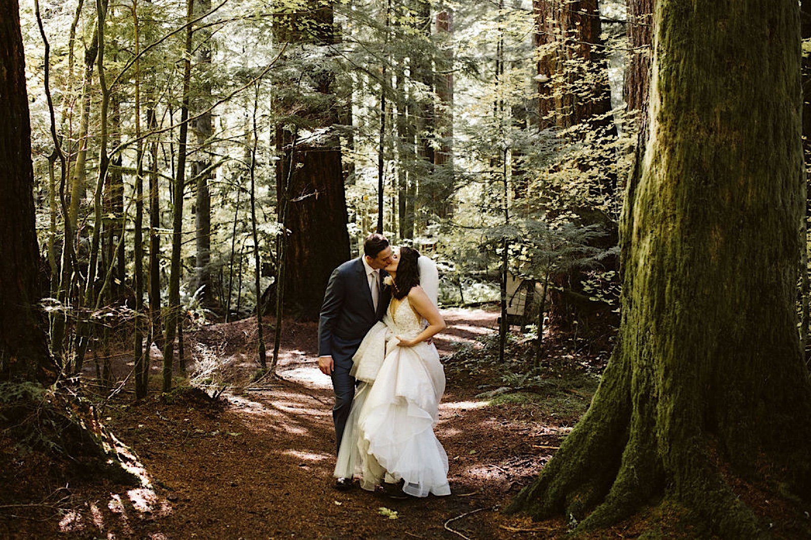 couple kiss in the woods at their mt. rainier elopement