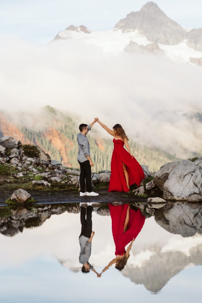 woman-in-vibrant-red-dress-with-clouds-and-mountain-views