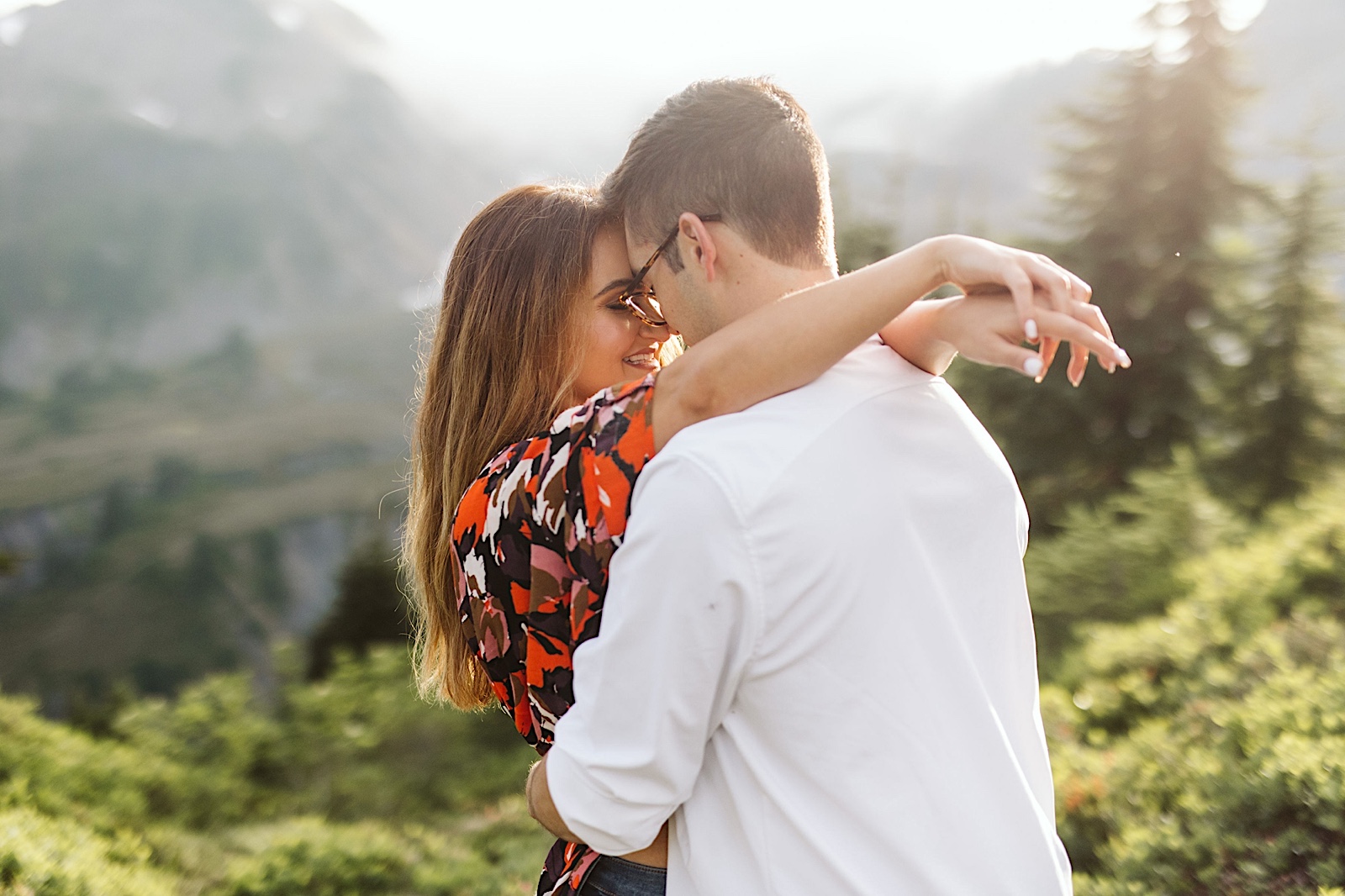 couple embraces at their engagement session at mt. baker