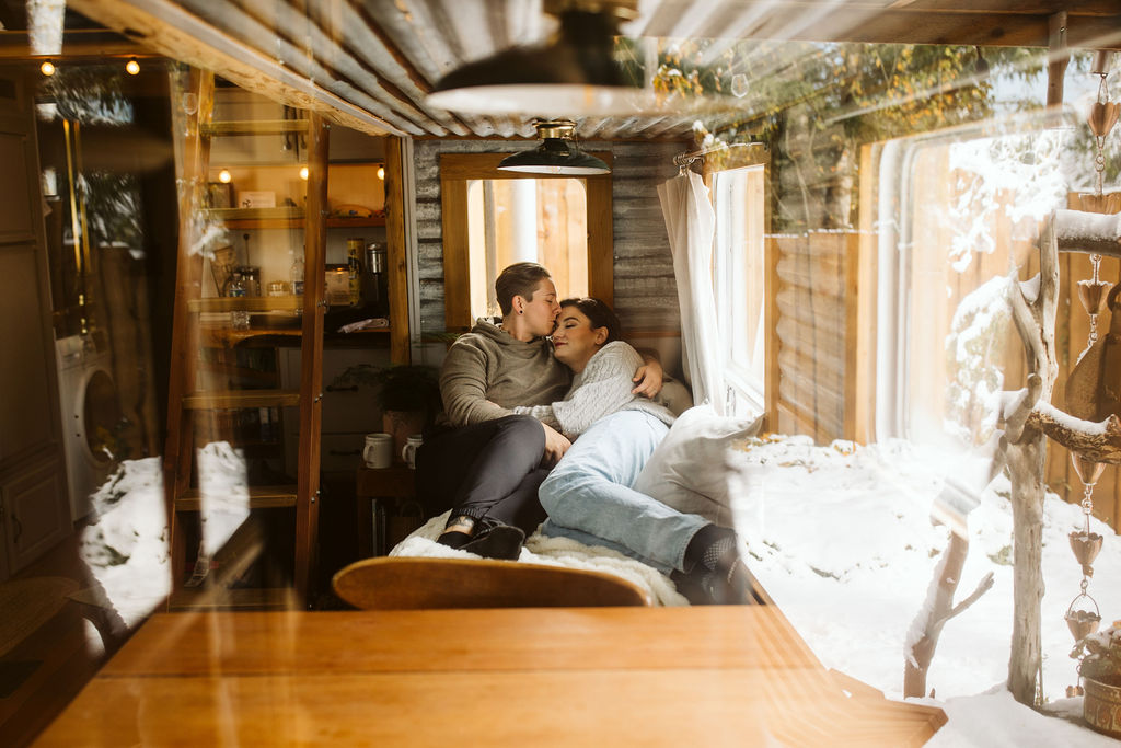 couple snuggles on bed during airbnb intimate wedding