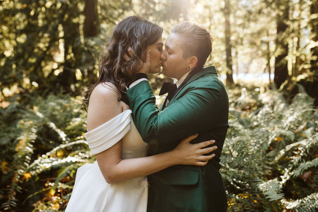 two brides kiss with foreheads against each other during olympic national park elopement