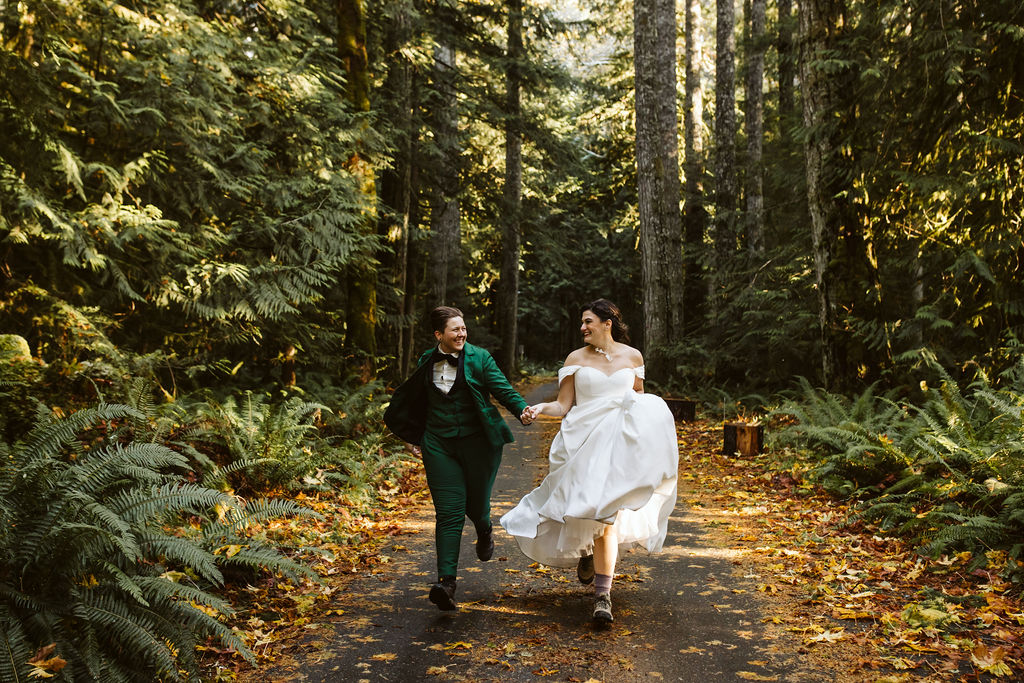 two brides run through forest during olympic national park portrait