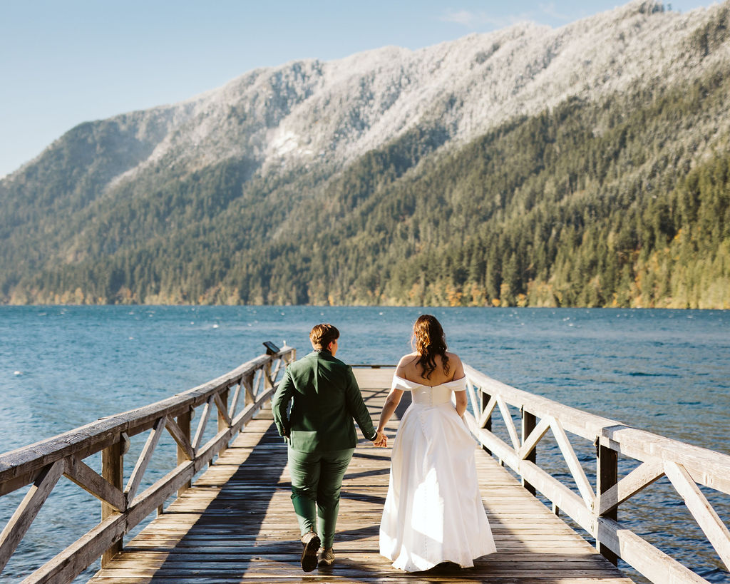 brides walk down dock on lake crescent during olympic elopement
