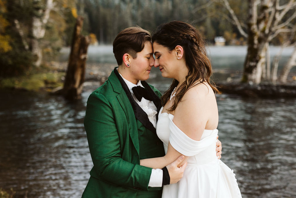 brides snuggle their foreheads against each other during lake crescent elopement