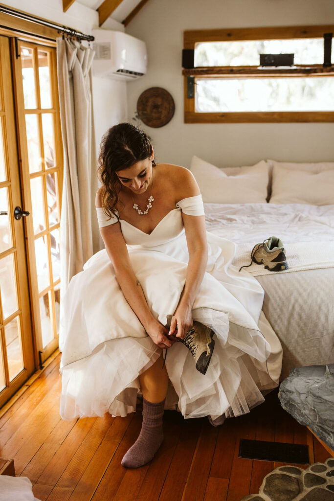 bride puts hiking boots on