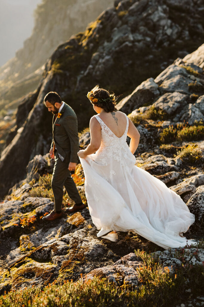 bride and groom walk amongst rocks during north cascades elopement