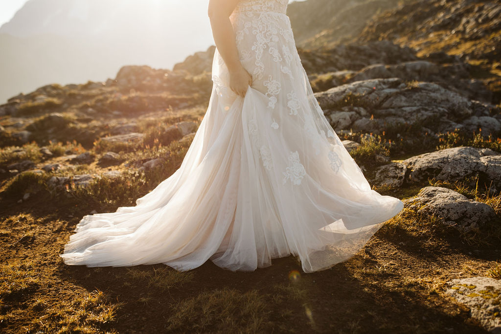 bride swishes dress in sunlight