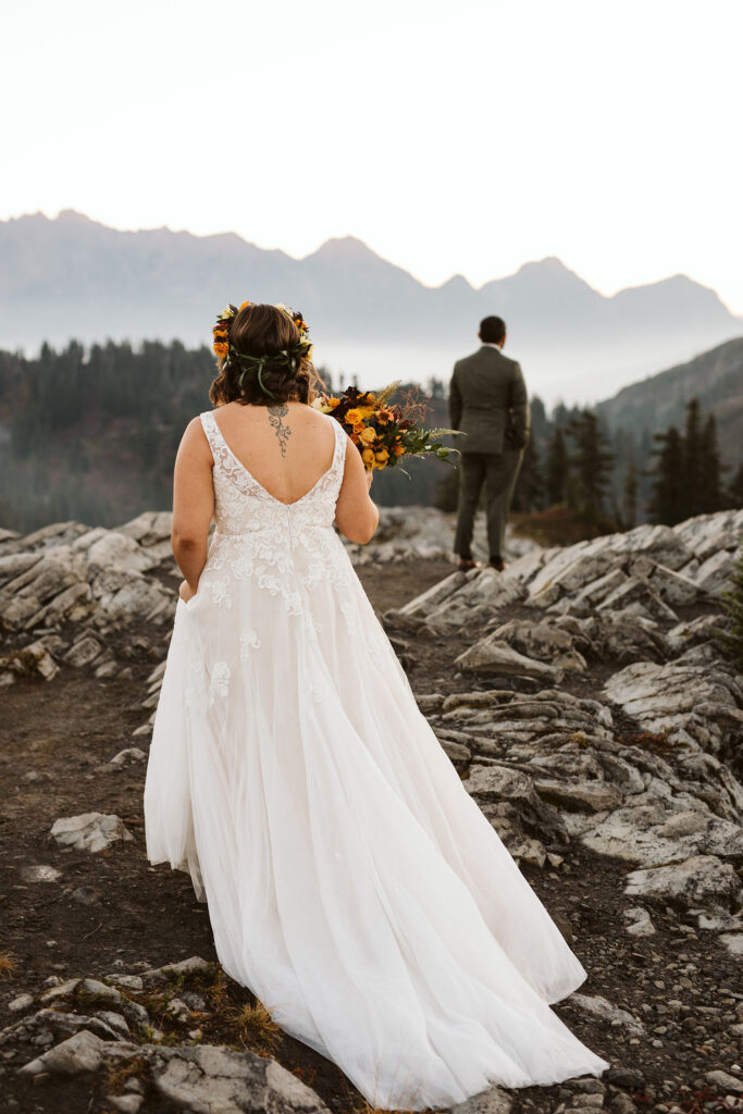 bride and groom standing on cliff during north cascades elopement