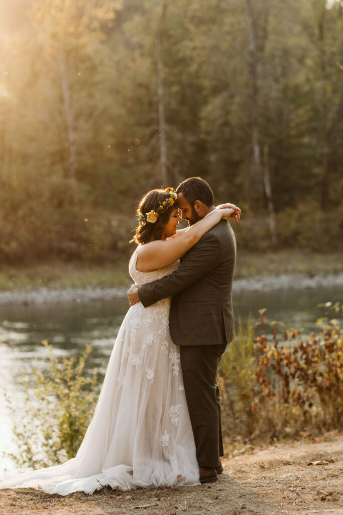 bride and groom hold each other in the sunset