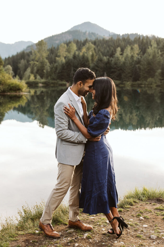 man holds woman close during gold creek pond engagement