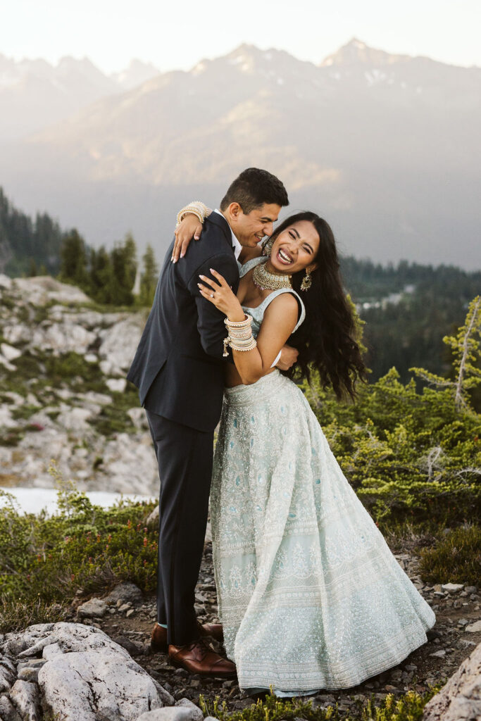 girl smiles with arms around boy during engagement shoot