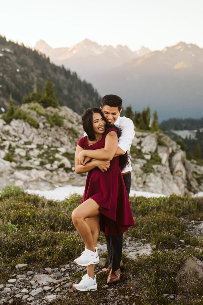 boy hugs girl from behind during engagement shoot