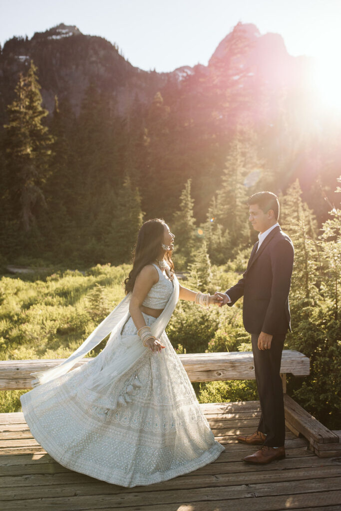 girl spins in sunlight in front of trees during mt baker engagement photos