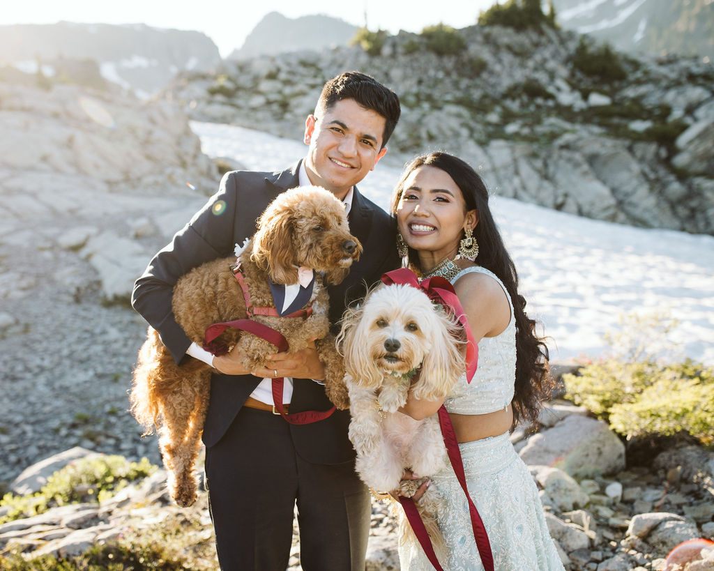 boy and girl hold two dogs and smile