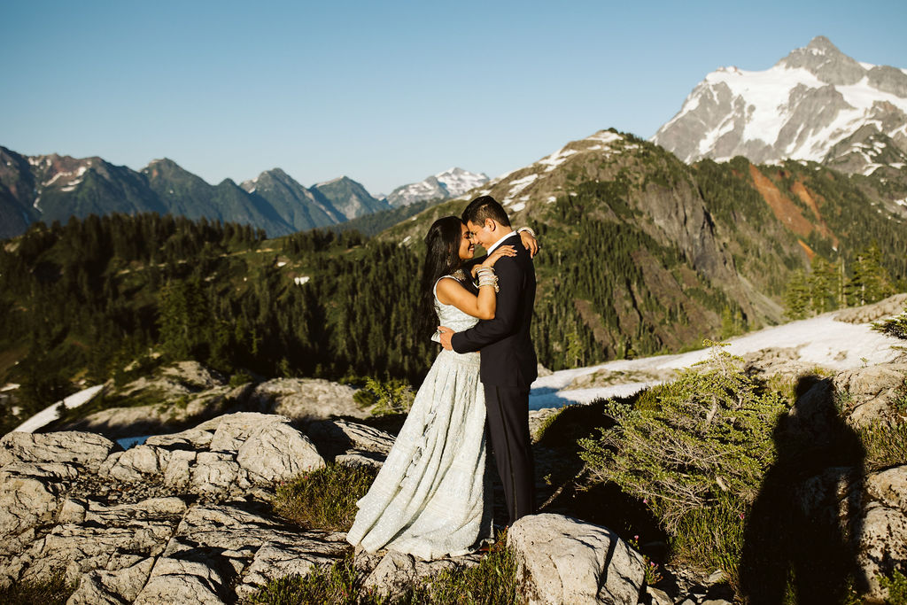 boy and girl hug on mountain top during north cascades engagement session
