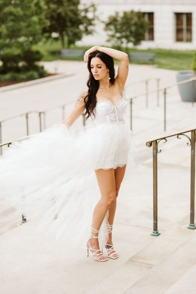 bride stands on the steps of the capital during elopement