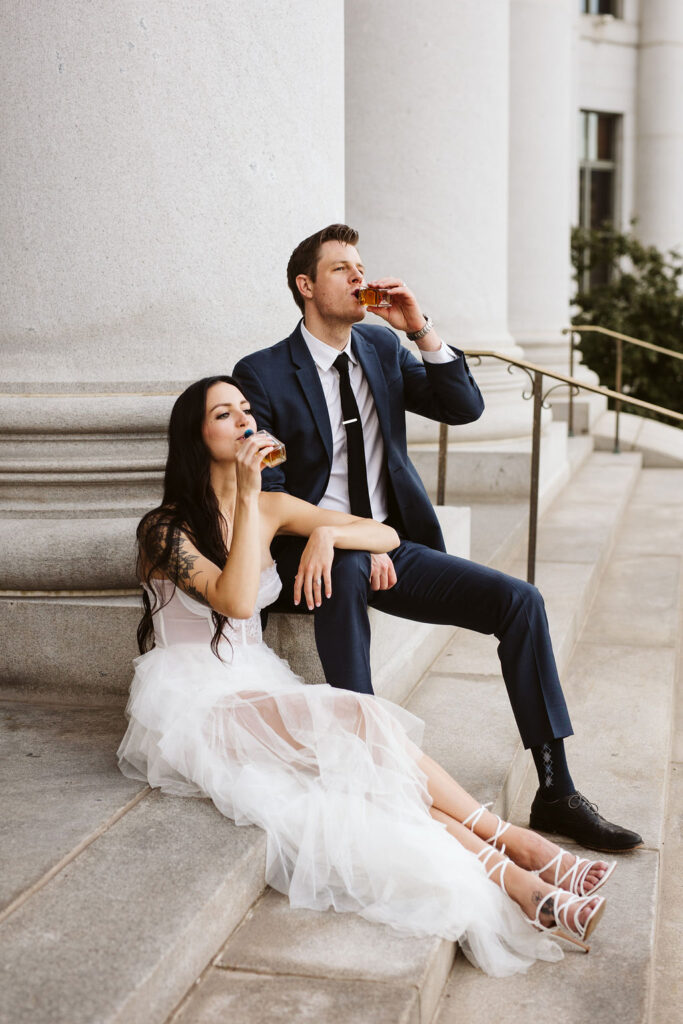 bride and groom drink on the capital steps